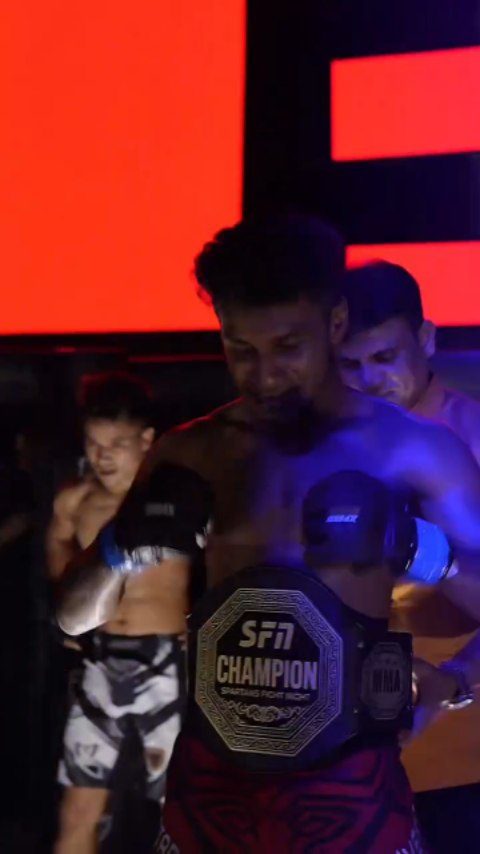 Champion under the lights with the belt